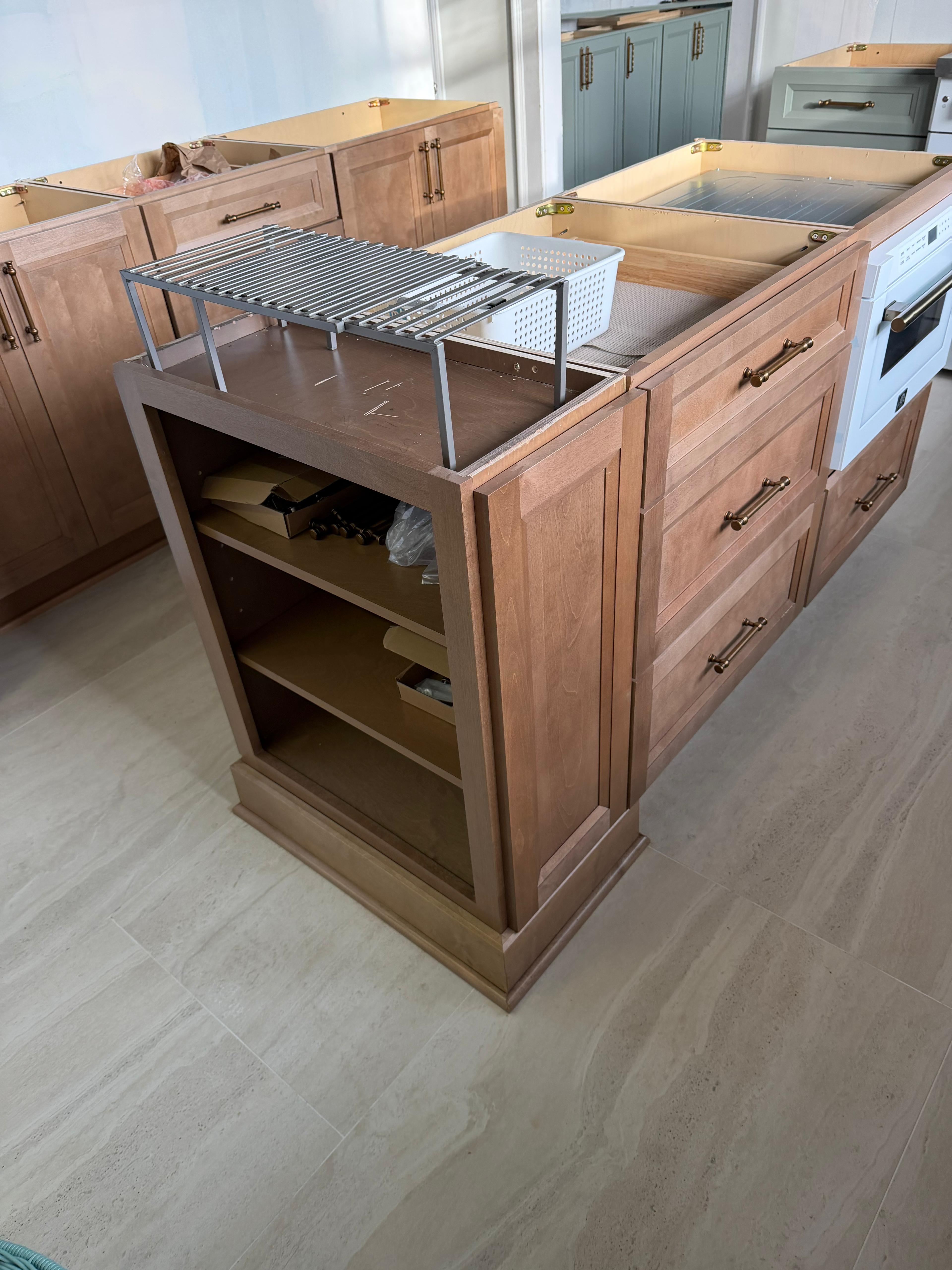 Kitchen island cabinetry during installation, before doors, hardware, and countertops.