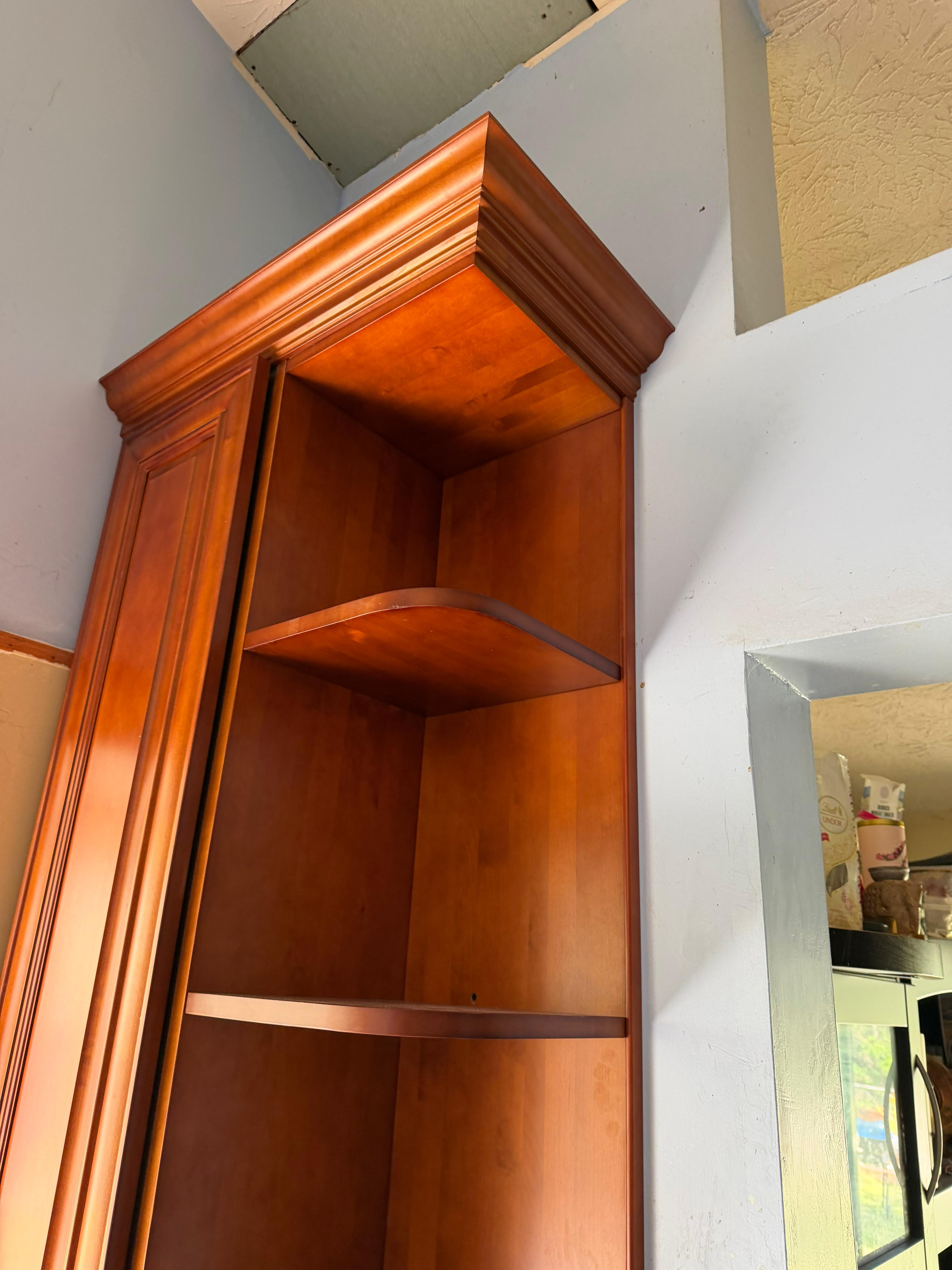 Wood cabinetry with open shelving and trim details.